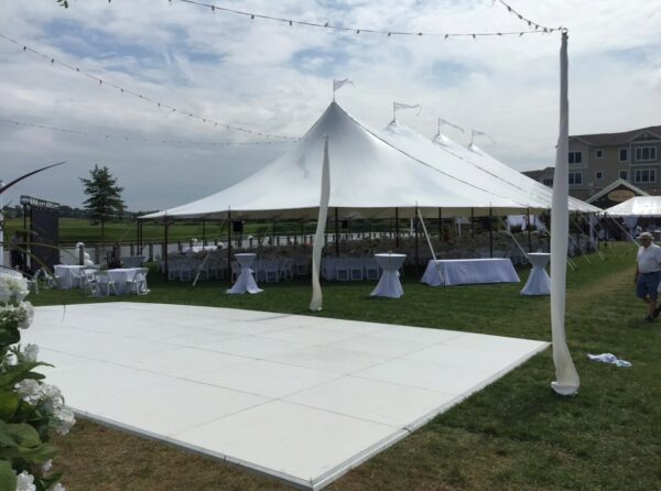 White Dance Floor Al Fresco Under Overhead Outdoor Lighting and a Sailcloth Tent