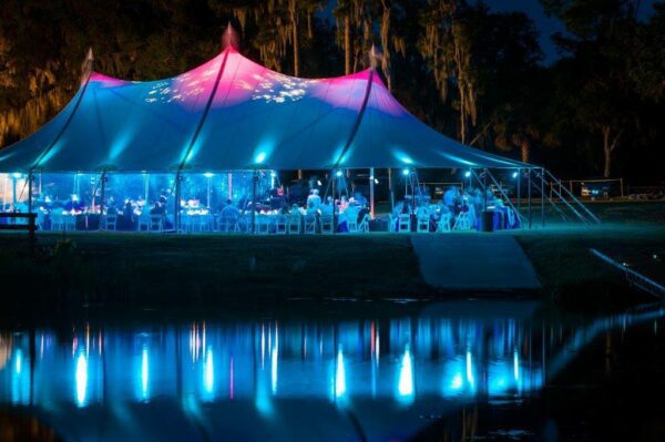 Sailcloth Tent with Uplighting at Night for an Outdoor Wedding