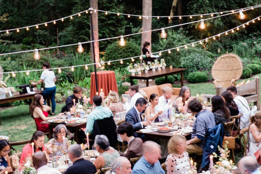Wedding Guests Family Style Seating under Al Fresco Lighting
