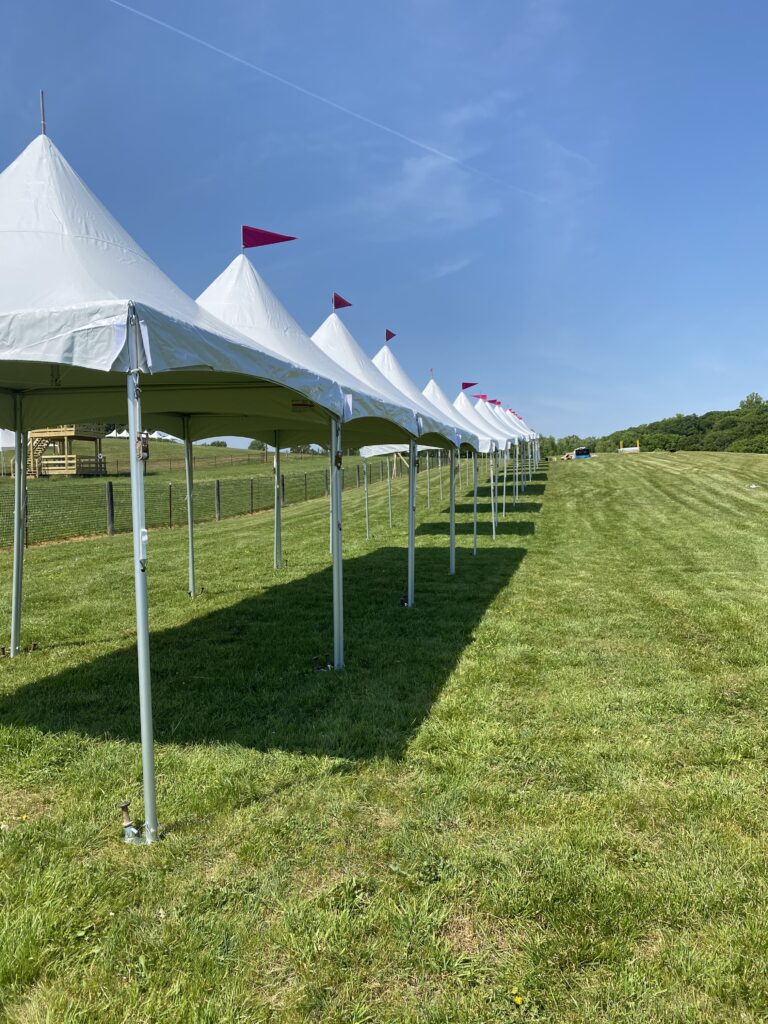 10' by 10' tents installed on green grass for upcoming festival near Philadelphia