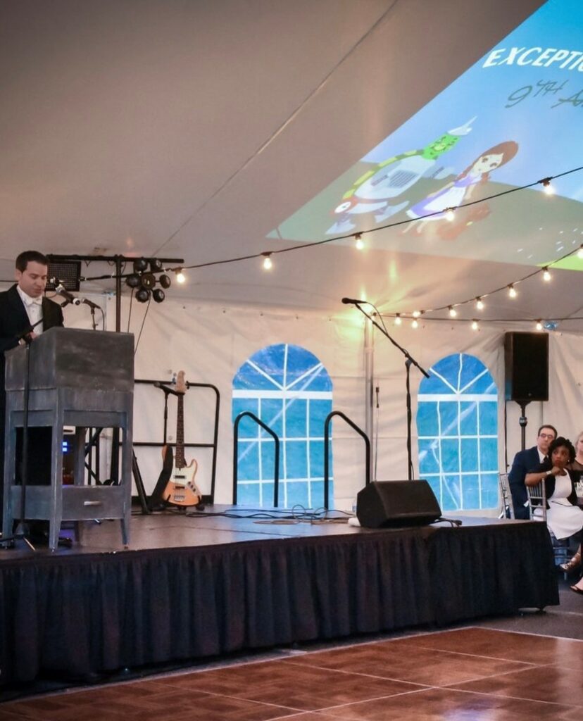 Stage set up under white tent 