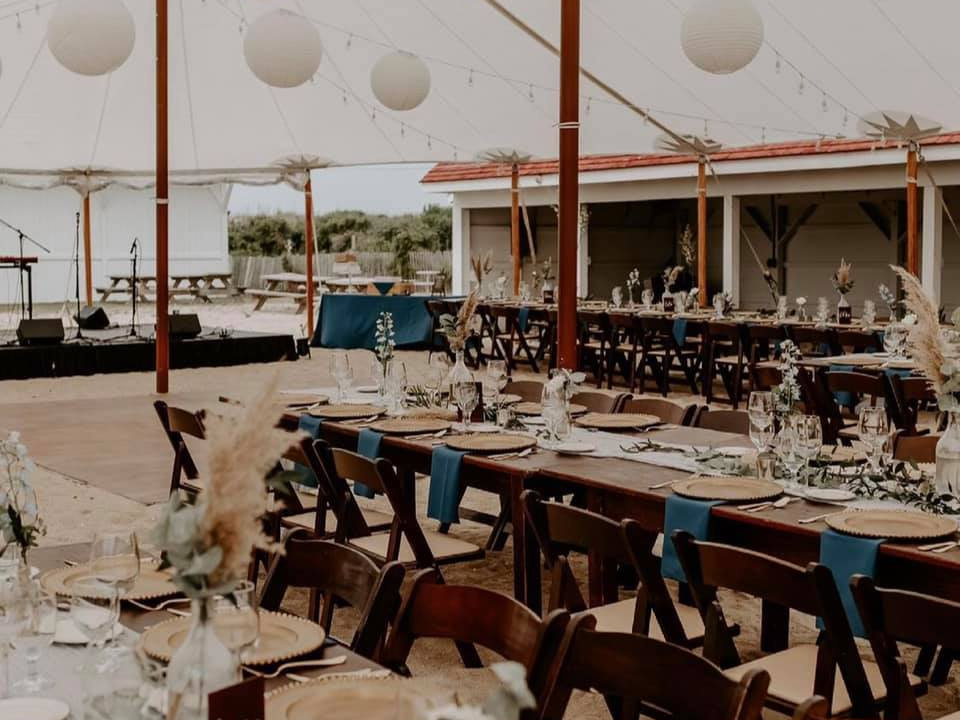 Warm rich colors under our sailcloth tent farmhouse tables by Collective Event Group, Rehoboth Beach Wedding