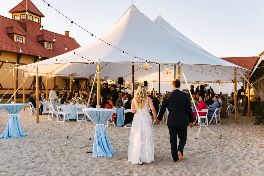 bride and groom walking to wedding tent