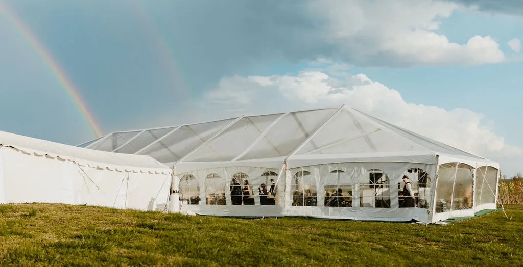 clear top wedding tent with marquee with rainbow in background