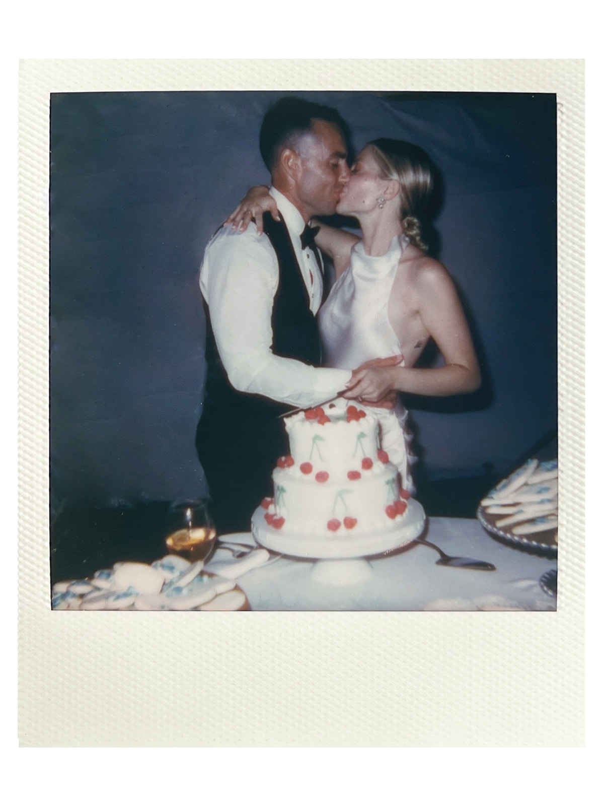 cutting wedding cake polaroid