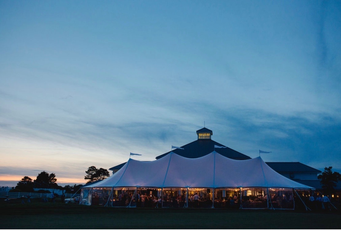 wedding tent with sun setting in background