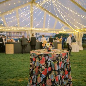 clear tent with twinkle lights, table with floral linen