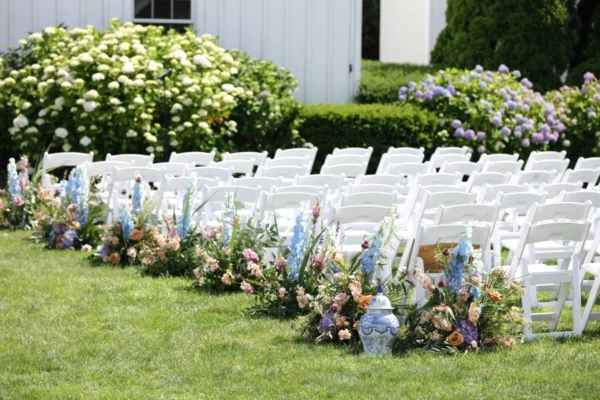wedding ceremony with white padded chairs