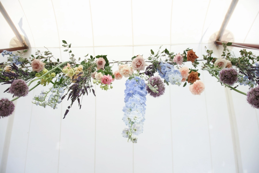 flowers hanging in wedding tent