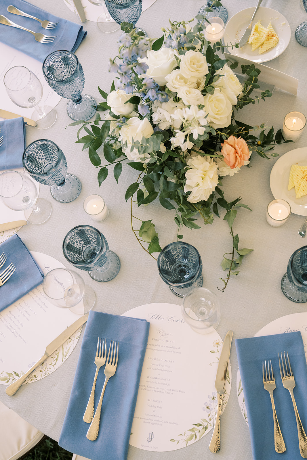 soft blue and white wedding reception with gold flatware