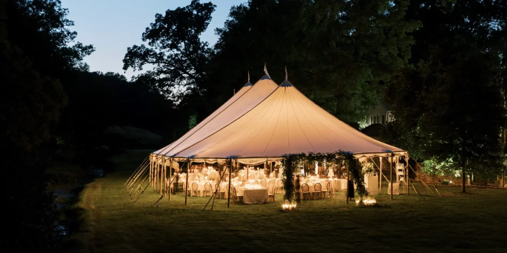 sailcloth tent in the evening with lighting glowing through tent top