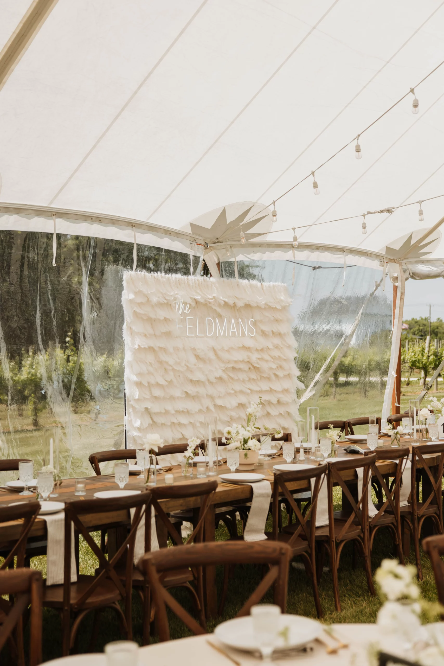 farmhouse head table with backdrop under a tent