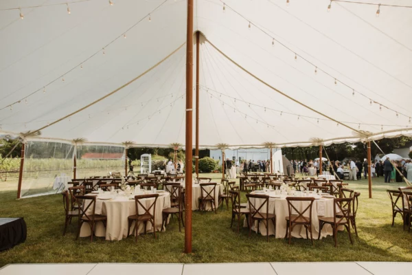 sailcloth wedding tent with round tables for guest seating