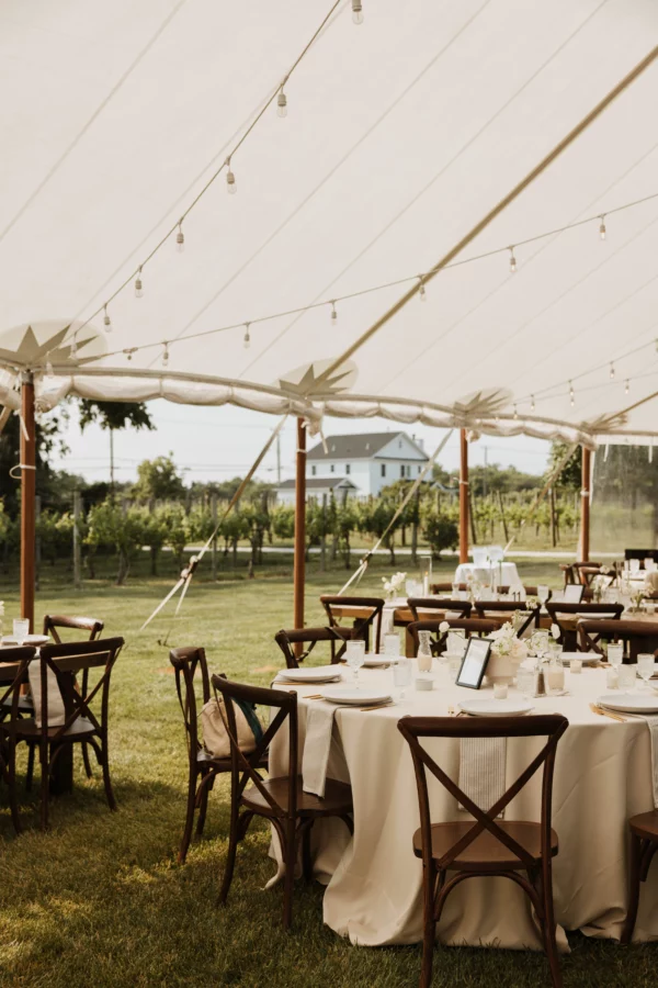 sailcloth tent with white tuscan bistro lighting and crossback chairs