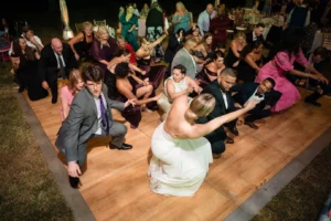 bride in white dress and guests dancing on dance floor