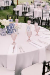 round table with pink water goblets and floral center pieces