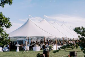 large white wedding tent set up for summertime wedding
