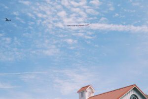 wedding sign airplane fly by on summer day