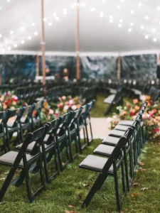 Black Padded Folding Chairs for an Indoor Tented Ceremony