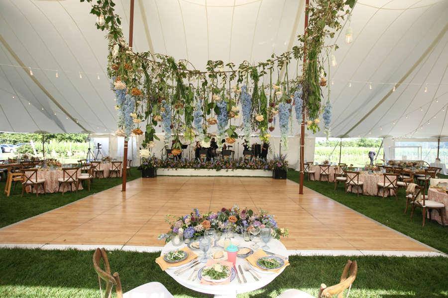 birch dance floor under tent with hanging florals