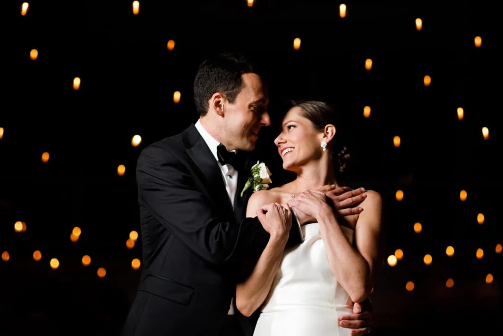bride and groom photo under twinkle lights