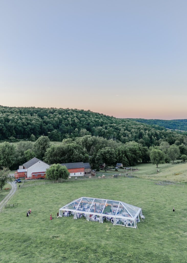 drone photo of clear top tent on grass