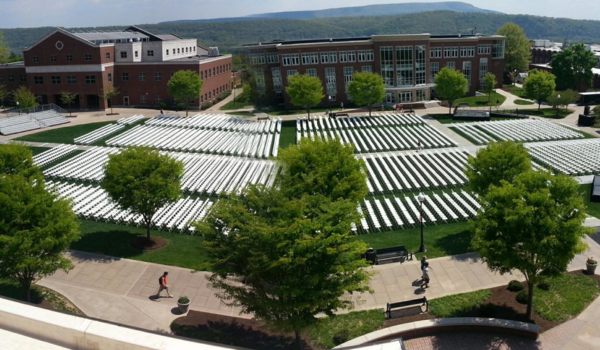 Drone View of white chairs set up for an outdoor graduation