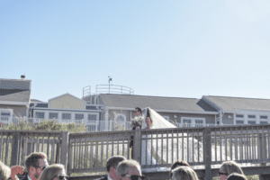 Bride and Groom entering beach from Childrens Beach House