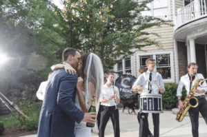 Bride and Groom kissing with outdoor band