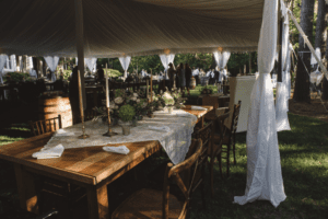 View of the Farm Table under the tent for a backyard wedding