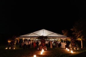 Cleartop tent at night with candle lit aisleway