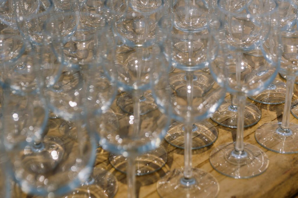 wine glasses lined up on wooden table