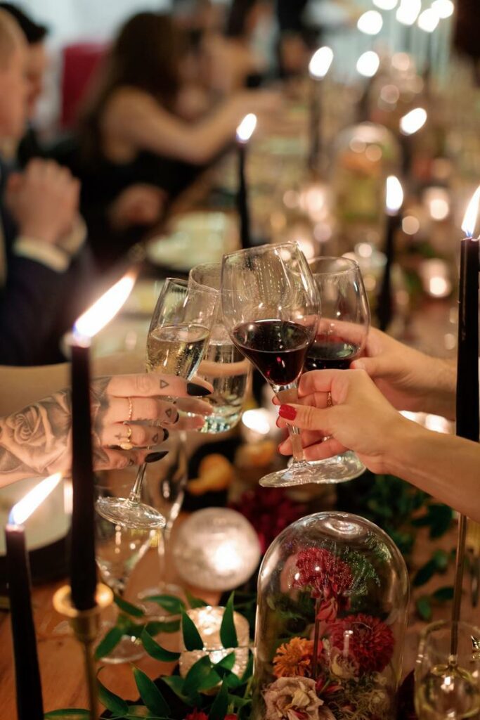 guests celebrating during dinner holding wine glasses