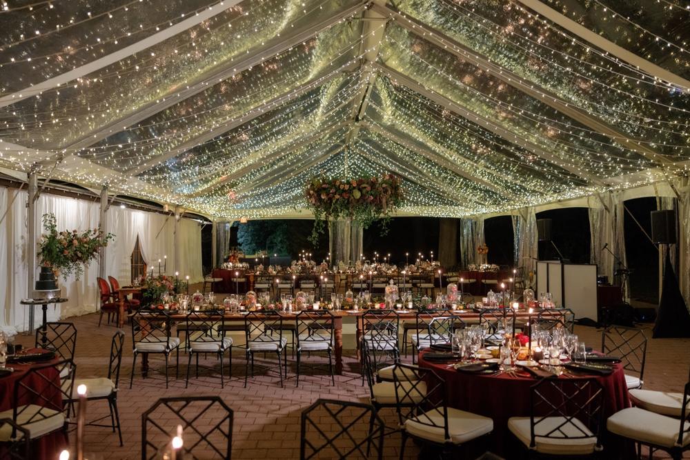 clear top wedding tent with waterfall lighting and floral chandelier