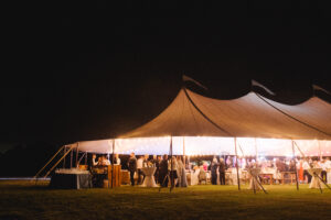 sailcloth tent, with lighting glow after dark, set up for wedding reception in Malvern PA