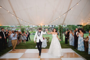 bride and groom having first dance on birch and white checkered dance floor