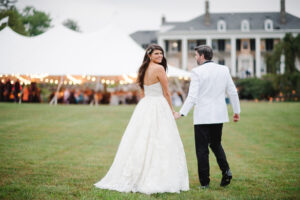 bride and groom standing outside of their wedding tent at their estate wedding in Malvern PA