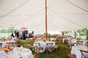 wedding reception tent set up with tables and chairs