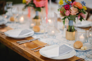 table setting for wedding reception on farmhouse table