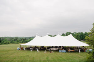 large white sailcloth tent set up on a lawn for an outdoor wedding in Malvern PA