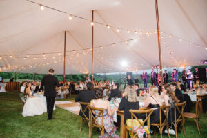 wedding reception tent with bistro lighting throughout.