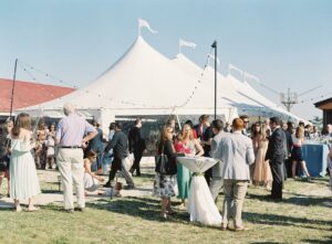 guests enjoying cocktail hour outside of wedding tent