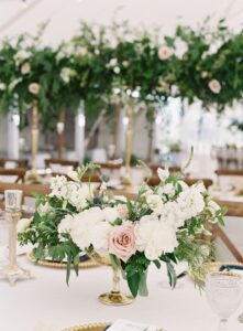 tented beach wedding tablescape with florals and greenery