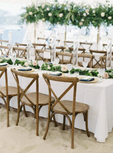 wedding reception tent set up with crossback chairs, and long banqet tables