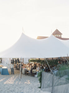 sailcloth wedding tent set on up the beach in delaware at indian river life-saving station